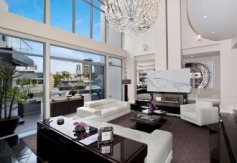 State-of-the-Art Architect designed masterpiece
Overview
Property Type
House
For Sale
$3,600,000
Garage
3
Carport
3
Web ID
2P1115
One of the most extraordinary homes located in an exclusive Gold Coast enclave is this waterfront property inspired by an Australian architect with over 80 squares of indoor/outdoor space showcasing views of the Surfers Paradise & Main Beach skyline , this home represents the best of modern architecture.
The attention to detail is apparent throughout this home with six bedrooms, six bathrooms and separate, New York style guest accommodation there is no denying this home is close to perfect. The expansive main level with its elegant sunken lounge leads onto a fabulous outdoor entertaining area or out by the plunge pool with BBQ area. This property offers numerous centres of activity for the entertainer and growing family alike.
The double storey ceilings give the property an air of immense height and space and with floor to ceiling glass panels allow unlimited views across to the city skyline and canals.
No expense has been spared in the finish of this residence featuring granite and marble floors with exclusive European lighting fixtures complemented by polished timber doors and feature walls.
The kitchen is a gourmet chef's delight with auto doors and Scandinavian appliances with black marble tops and many features too numerous to mention, There is also a concealed wine cellar for the avid wine buff.
Enjoy lazy days on your own private sandy beach or cool down with a dip in the plunge pool. For the boating enthusiast there is a jetty complete with boat shed and winch. The property comprises three lockup garages and an additional three secure car spaces to cater for visitors.
Beautifully landscaped gardens with imported water features and fishponds offer a perfect backdrop for this property which is nothing short of superlative.
Call for an inspection today to view this extraordinary masterpiece of design and style