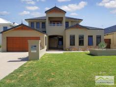 6 Lautoka Rise, Mindarie WA Beaumonde homes have been built on reputation since 1986 and this stunning 2008 built home is a classic example of the style, quality of craftsmanship and attention to detail that Beaumonde demand. The owners of this gorgeous home insisted on important facets of the build to ensure their home exuded sophistication and quality like 38 and 37 course ceilings, imported Italian porcelain tiles, pewter granite, Eastern Blackbutt flooring from Grandwood floors and Daiken Reverse Cycle Ducted Air conditioning. Not only is this home a stunning/quality built property but it is located in a very desirable position only minutes walk to the Mindarie Marina, Claytons beach the schools and shops. Gorgeous ocean views greet you as soon as you walk upstairs with the bright blue sparkle of the pool below. This home is faultless, see the list of features below: Level One: Inviting generous decked porch area with double door entry Classic beautiful lobby bringing you into the formal lounge Formal Lounge the perfect place to great your guests Double Doors lead to the open Family/Dining/Kitchen-the most important and most used area of the home with recess area to family room for the TV, a bank of glass surrounding the dining area. Huge kitchen with Pewter granite bench tops that have shark nosed edging, massive walk in pantry, central island work area giving you uninterrupted views of the swimming pool, quality under bench oven and gas hot plate with overhead stainless steel and glass range hood. Appliance cupboard and good sized fridge recess plus plenty of preparation area Leading from the hub of the home you enter the purpose built Theatre Room with dual access to the outdoors so can be a multi-purpose room great as a big play room when the children are small Three very generous children?s bedrooms all with double robes and of course those 38 course ceilings Main Bathroom has a separate WC with powder room which then leads to the main shower and the oval bath Walk in Linen giving plenty of storage Well equipped laundry Level Two: Beautiful elegant staircase leading to the top level Huge open space consisting of the Study and the upstairs Lounge Kitchenette/Bar upstairs with glass splashback, fridge, microwave and sink Massive balcony with beautiful ocean views Main Bedroom Suite with private balcony thru double doors Massive walk in robe Amazing En suite with double basin vanity, huge oval spa bath, generous shower and separate WC Extras you will enjoy: Outdoor Cabana with decking and timber lined ceiling that overlooks the pool Stand Alone bricked Shed ? ideal to convert into shower block Ducted Reverse Cycle Air conditioning Solid timber flooring and Italian porcelain tiling Warm timber double front doors Storage under the Stairs Huge double garage with sectional remote door Quality light fittings and down lights Wrap around below ground swimming pool with water feature Extensive limestone paving surrounding the home Grassed area for the kids to play Side access thru timber gates Completed in 2008 Approximate size of home in total 380sqm Block size 612sqm