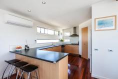 2 Eastview Terrace, Jan Juc VIC Enjoy the Eastview Lifestyle! If you are seeking out a home in Jan Juc it stands to reason that you are drawn to the water, what better way to fulfill that need than with a view of the ocean to wake up to every morning. Situated in one of the quieter pockets of a relaxed coastal village, this property in Eastview Terrace takes full advantage of its position which is in easy walking distance to the beach, golf club and shops ensuring you enjoy the landscape and local lifestyle. Contemporary in design, the double story home makes the most of an easy care block of land by maximising both living and outdoor space. Inside, four generous bedrooms on the ground floor are serviced by both a modern family bathroom and ensuite to the master with all except the fourth bedroom enjoying the benefit of WIRs. Providing direct access to the gardens (complete with large garage, double carport and secure parking for boat/caravan), a large second living area on this level provides flexibility and a perfect retreat for the younger members of the family. The upper level is dedicated to everyday living with a bright, spacious kitchen flowing through the dining and family rooms (beyond the handy powder room) onto a well_positioned balcony that offers sweeping, panoramic views over the ocean. Clever design elements, such as the north facing highlight windows, flood the room with natural light giving further depth to the richness of polished timber floorboards whilst, the morning sun through the expanse of windows opening to the balcony invite lazy breakfasts with a paper and the reminder that you do indeed, live by the beach. The simplicity of good quality, well maintained fixtures and neutral tones makes this a comfortable, functional and laid_back home to live in. It is a welcoming home that offers families an opportunity to live their coastal dream without fuss but with a real emphasis on capturing the desire and making it real!