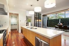 86 Wells Road, Beaumaris VIC Auction 10:30am, Saturday August 9, 2014 $1,295,000 - $1,395,000 3 B 2 b 2 C Watch property video A Statement of Style, Space & Design Get ready to impress with this up to 4 bedroom, 2.5 bathroom spectacular statement of architectural style boasting an exceptional sense of space & an innovative central entertainment zone designed to bring the outdoors in. Superbly positioned only two doors to Illaroo Reserve & pre-school, and a short stroll to the beach, Seaview shops & cafes, schools and the bus. Beyond a striking copper façade & oversized pivoting door, warm Jarrah & polished concrete floors, expanses of glass & soaring voids define a beautifully balanced layout flooded in northerly light. Vast living zones are connected to multiple outdoor entertaining areas including a sun drenched central courtyard with glass cafe-style sliders (pizza oven & pond), a private front courtyard with boxed Merbau seating & a shimmering black tiled pool set in rear landscaped gardens. A luxurious Caesarstone & stainless steel appliance kitchen with island bench, butlers' pantry, dual dishwashers & a built in Miele coffee machine is at the heart of inviting family (gas OFP), living & dining areas. A ground floor study & powder room could double as guest quarters; and complements spacious upstairs bedrooms, 2 with a dual access bathroom & built in robes, and master with his & hers walk in robes and dual vanity, double shower en suite. Impeccably appointed with all the extras including 3 metre ceilings upstairs & down, extensive storage, ducted heating, evaporative air conditioning, indoor/outdoor surround sound, intercom, security alarm, plantation shutters, Shugg windows, automatic blinds (for void), laundry chute, garden lighting, irrigation, gas pool heating and a direct home access auto double garage. For more information about this statement entertainer please contact Andrew Campbell at Buxton Brighton on 0419 366 545 http://www.86.wellsroadbeaumaris.com/