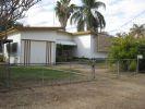 20 KITCHENER ST CLERMONT, QLD 4721 Gosh remember back in the days of She-Ra and He-Man!! With their swords of protection and power, they were indestructible. Reminds me somewhat of this house...indestructible...as solid as a rock!! And not just solidly built either, but a solid layout...three large bedrooms, all with built ins and all along the eastern side of the house. There is a lockable garage at the front along the western side of the house, and alongside this is an additional carport. An awesome entry porch with access to the garage, and lockable storage units invites you into the home. The open plan living & dining areas are in the centre of the house, and are huge, with built in shelving and shadow features. In addition there is the well equipped kitchen with a servery opening onto the dining area. From the dining area, head down a few stairs to the entertaining area. Behind the kitchen is a large storage cupboard and laundry with a ramp down to the clothes line.