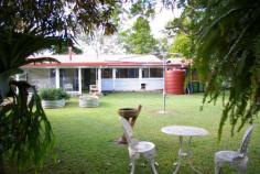 1111 Maleny Landsborough Road, Maleny ALL REASONABLE OFFERS WILL BE CONSIDERED. Very neat three bedroom low set brick home on a lovely flat 2187m2 which has a dog fenced back yard, two garden sheds, several bush houses and an orchard. Features include high ceilings, slate tiled floors in the kitchen and dining area. The spacious master is air conditioned and has a big wardrobe, other bedrooms have built-ins. The kitchen adjoins the family/dining area and there is a separate lounge room. A covered entertainment area protected from the weather ideal for BBQs and outdoor relaxing is added bonus. Lots of other extras include ample storage space, wood burning fire, 12 solar panels, security screens, irrigated gardens, auto sprinklers, 27,000 gallon rainwater supply and a remote control lockup garage. There is also a large caravan and boat shed. Only a few minutes drive into town this property represents EXCELLENT VALUE FOR MONEY and should be added to the list of any buyer looking for a nice parcel of land with a comfortable home at an affordable price. Building and pest report available.