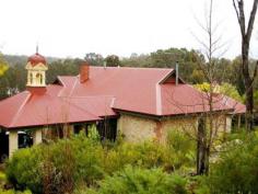 118 Dunnet Rd Nannup WA 6275 A WORK OF ART If you desire something truly unique, exciting and elegant this beautifully converted Masonic Lodge and cottage set on its own one acre site would tick all your boxes. Built in stone and renovated using the services of a highly respected heritage architect it breathes elegance and style. Viewing the property from the top of the block it speaks for itself with its elegant rooflines including carport and belvedere cupolas. Stunning views of the tourist end of town including the village green from the property. French doors to match original windows, bricked facia to stonework to set off window and door spaces, well laid out gardens with original Busselton brick mandalas winding their way through bird attracting shrubs and flowers. Internally, a classic restoration with original polished floorboards throughout, the large open hall has been converted into a superb living space and feature country kitchen with a study nook. Two original rooms at the back of the hall have been created into a master suite of bedroom and sitting together with a magnificent old world bathroom. Feature rock steps lead to the guest cottage built again from the restored Masonic roof tin featuring the ‘Orb’ stamp. Original art deco leaded lights in two of the windows. The cottage comprises of a comfortable totally self contained bedroom, lounge, kitchen and bathroom with fabulous views over surrounding hills. A large utility shed that doubles as an artist studio and a small garden shed complete the picture. Owners would like to rent the studio/cottage back once the property is sold, providing a small income stream for the new owner. The property has been surveyed for subdivision