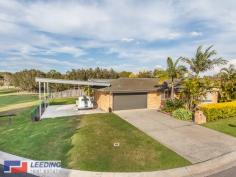 7 Penleigh
Boondall Qld 4034 Privately located at end of a quiet cul-de-sac adjacent to acres of beautiful parklands this modernised, low maintenance, family friendly home is situated in arguably one of the best positions that Collage Green has to offer. The master bedroom is a parents retreat, positioned at the front of the property overlooking the beautifully maintained gardens and paved courtyard. It offers a private en suite and large mirrored built in robes. The other 2 bedrooms (both with built in robes) lead to the separate tiled family room at the rear of the home. At the centre of the property is the functional gallery styled kitchen with gas appliances and a large breakfast bar that leads to the L shaped lounge and dining rooms with polished bamboo flooring. The main bathroom comprises of a separate bath and shower and features ample built in storage. The fully ducted air conditioning throughout the home makes it comfortable all year round. Outside is what really sets this home apart from the others. The double side access leads to one of the huge skillion roofed areas that has the ability to house the largest of boats or caravans. This combined with the remote controlled double garage with direct internal access to the home offers a total of 4 car undercover accommodation. At the rear of the property is the second even larger undercover area, flanked by tropical palms and frangipanis it is the most ideal alfresco area. With both areas fully insulated and wired for surround sound, this property can house the largest of family functions. If entertaining is not for you, then sit back and enjoy a glass of wine (or 2!) in your heated 6 person hydrotherapy spa overlooking the tranquil parklands, listen to the wildlife and RELAX! Positioned within walking distance to both primary and secondary schools and to Boondall train station. With easy access to the Gateway Arterial road and just a short drive to 3 major shopping centres you will be hard pressed finding a home with this many features in such an idyllic serene location. This is not your average home- you must inspect to appreciate.