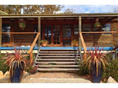 Panoramic Australian bush views from the balcony of this very private character log cabin, gives the feeling of being lost in the bush, just 5 minutes from the F5 freeway. This property offers a lot with Dressage arena, a great water bore, a dam and paddocks for the pony. Suits any number of buyers being perfect for a weekender or for a large family.