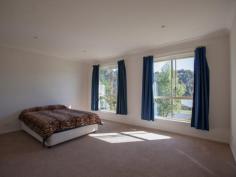 Bermagui NSW 2546 A high quality 3 bedroom ensuite home with great street appeal, plus additional boat/caravan garaging. A sunny and spacious open plan design features a split level living space at one end, that adds interest and variety to the design. At the other end sits the kitchen with stainless steel oven and ceramic cooktop, and access to a paved rear patio. The living space and front verandah enjoys northerly views over the surrounding area with ocean glimpses in the distance. As well as a double garage with internal access to the house, there is a detached metal garage with extra high clearance especially for boats or caravans.
