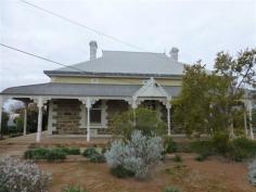 11 West Terrace Orroroo SA 5431 This classic return verandah villa is situated in an ideal residential location and offers 3 spacious bedrooms all featuring ornate fireplaces. There is a magnificent arched hallway with front stained glass windows plus the home still has its original doors and skirtings adding to lovely retained character of the home. Beautiful ornate ceilings are also featured throughout the home. There is a formal dining room with ornate fireplace plus a huge lounge/family room also featuring an open fire place and reverse cycle air conditioning. The kitchen with casual dining area offers ample space and storage plus a reverse cycle air conditioner. The home has two bathroom areas with the main bathroom featuring a separate shower and claw foot bath. A separate inside toilet and large laundry area completes the inside of the home. Outside includes the return bull nose verandah, approx. 1500 gallons of rainwater storage, stone garage and storage shed which along with the home are all set on a large level allotment with the original stone fencing along the front boundary. Inspection of this home is highly recommended.