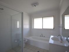 Bermagui NSW 2546 A high quality 3 bedroom ensuite home with great street appeal, plus additional boat/caravan garaging. A sunny and spacious open plan design features a split level living space at one end, that adds interest and variety to the design. At the other end sits the kitchen with stainless steel oven and ceramic cooktop, and access to a paved rear patio. The living space and front verandah enjoys northerly views over the surrounding area with ocean glimpses in the distance. As well as a double garage with internal access to the house, there is a detached metal garage with extra high clearance especially for boats or caravans.