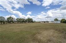 566 Moorlands Road Meadowvale QLD MORTGAGEE EXERCISING POWER OF SALE BEING SOLD UNDER THE HAMMER ON 27th OF SEPTEMBER 2014 @ 11am Set well back from the road and hidden by established landscaping, the home features a large open and flowing design, large living areas with floating timber floors, high ceilings, air conditioning and ceiling fans. Functional air conditioned kitchen with a bench top stove and wall oven. Although the kitchen & appliances are dated, the floor design & characteristics of the home would make installing an ultra-mod spec kitchen look appropriate & fantastic, this improvement alone would vastly increase the value of the property. 3 carpeted bedrooms with ceiling fans and a new nearly complete modern bathroom with spa bath, just some minor finishing is needed here. 4 bay powered shed with concrete and paved flooring that can also be access via the rear veranda. Ideal workshop setup having a drive through bay. Flat, fully fenced, 6,000sqm (approx. 1.5 acres) block being mainly clear with boundary trees. The perfect size for a lifestyle property, not too big that it’s unmanageable but not too small, very few limits on what could potentially be done with the land.