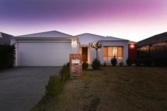 11 Parkinson Road Banksia Grove WA 6031 This stunning 4 bedroom 2 bathroom home, built by Ross North, is guaranteed to impress. Boasting entrance hall with high ceiling; shoppers access from the garage; master bedroom with wooden window shutters, walk in robe & ensuite; fitted laundry; linen/storage closet; spacious, open plan family & meals areas with high ceilings; quality kitchen with feature drop lighting over the stone bench top with breakfast bar, double fridge/freezer recess, corner walk in pantry & stainless steel appliances including dishwasher, 900mm cook top & rangehood; separate home theatre with built in book shelves; 3 further double bedrooms with built in robes & family bathroom with bath & shower. This property also benefits from ducted, zoned, reverse cycle air conditioning throughout; alarm system; quality floor tiles; solid Blackbutt flooring to all bedrooms & home theatre; skirting boards; neutral decor; Crimsafe security screens to the front, laundry & back doors, super-fast FUZE internet connection and energy efficient LED downlights. Outdoors features an alfresco with downlights & exposed aggregate flooring; low maintenance, paved garden; side gate access; automatic reticulation; double, remote garage with door to the back garden & exposed aggregate driveway. All this on an easy care 450sqm block, with parks such as 'Pit Stop Park' & 'Discovery Park', Banksia Grove Catholic Primary School, shops & all local amenities close by. With the New Banksia Grove Shopping Village & Banksia Grove Secondary School underway and plans for the bus route to be extended through the newer areas of the development over the next couple months, Banksia Grove is an up & coming suburb, making this property a sure fire winner!