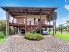 19 Harwood Dr Babinda QLD 4861 Stunning Pole Home with Rainforest Views. Set in a quiet close backing onto a small park and overlooking the mountains this modern, high set pole home is brimming with possibilities with separate living and multiple rooms. Unique in its design you could, with council approvals, offer a bed and breakfast, holiday let or just retire happily in waterfall country. * Fantastic street appeal the home is set on an 800m2 corner block with room for a shed although there is ample room downstairs * Beautifully presented, fully fenced with two entrances, mostly air conditioned and plantation screened windows throughout * French doors open onto timber decks to capture the views and breezes * Polished timber floors throughout with raked ceilings and exposed timber beams in the living areas * Open plan living, dining and kitchen with a walk in pantry, a 900cm gas oven and 5 burner cook top for the cook in the family plus a dishwasher and island bench * There are 2 bedrooms with walk in robes in the front section of the home along with a large, modern, 2 way bathroom with separate shower and bath * This bathroom opens onto a small deck and offers access to another bedroom or office and the laundry in the middle section of the home * This 3rd bedroom has a second door which flows into an almost self contained 2nd section of the house with an entrance/kitchen area, a large bathroom, a living room or 4th bedroom and the very spacious master bedroom. * Downstairs has 2 separate rooms which are security screened and just need a paint, floor coverings and roof linings. One room is a good storeroom but could be a small bedroom and the other is very large with endless possibilities. * Room for 2 cars in tandem plus a 3rd car or boat, wired for generator and gas hot water This property could suit FIFO workers, a teenager's retreat, guest quarters and a rental income stream or can just be a fantastic family home
