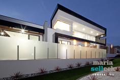 14 Fereday Street, Weston ACT 2611 Emanating a luxurious resort-style ambiance, this masterpiece of substantial proportions has been finished to exacting standards with emphasis on open-plan family living, natural light, space and the exquisite views, making it a rare offering of truly indulgent living. The impressive foyer opens to reveal an inspired design incorporating multiple living spaces, all featuring an extensive use of glass, striking high ceilings and seamless extensions into multiple outdoor living areas. At the heart of the home, the immaculate gourmet kitchen, boasting stone waterfall benches, walk-in-pantry and the finest appliances, overlooks spacious open-plan formal and informal living areas, including a rumpus and study. The rear of the home comprises three large bedrooms, all with built-in-robes and external access to outdoor living spaces, superb spa bathroom with two-way access, separate laundry and double garage with generous storage. Extending from the impressive wood staircase, the private second storey offers the master bedroom with expansive parent's retreat, walk-in-robe, stunning ensuite and balcony with inspiring sunset views. Other features include ducted heating and cooling, alarm system, video intercom, low maintenance landscaped gardens, outdoor kitchen, eight-person spa, and other luxurious appointments. Located in one of Western Creek's most desirable locations amongst other high-quality homes, this stunning and light-filled residence of approximately 290sqm of living space incorporates an array of designer finishes and a seamless outdoor flow to ensure a lifestyle of privacy, prestige and effortless entertaining in a highly sought-after location.