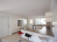 Bermagui NSW 2546 A high quality 3 bedroom ensuite home with great street appeal, plus additional boat/caravan garaging. A sunny and spacious open plan design features a split level living space at one end, that adds interest and variety to the design. At the other end sits the kitchen with stainless steel oven and ceramic cooktop, and access to a paved rear patio. The living space and front verandah enjoys northerly views over the surrounding area with ocean glimpses in the distance. As well as a double garage with internal access to the house, there is a detached metal garage with extra high clearance especially for boats or caravans.