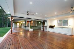 9 Warrandyte Court Camp Mountain QLD 4520 Position is a key feature that differentiates this property from others in the Samford district and indeed acreage properties in Brisbane generally. Only 7 mins to Ferny Grove train station means transit to the city centre and events is easy and quick. Driving time is only 30 minutes to the city. Uniquely situated at the base of Camp Mountain, bordering the D'Aguilar National Park, with nature trails right at your doorstep, lies this hidden gem on 3.75 acres. Privacy is paramount and the new owners will enjoy a chilled and relaxed lifestyle with the assets that abound. A recent extension by Garth Chapman Queenslanders has created a large 6.8 x 6.5m outdoor pavilion. Such a beautiful space, it has everything you need for entertaining in style built in seating, BBQ with stone bench tops, storage areas and tv points, ready for your widescreen TV. Take 2 steps down from the pavilion and you are in your massive, granite paved sparkling pool area with semi frameless glass fencing, hot water outdoor shower, beautiful water feature and a pump room that is impressive in itself, allowing convenient storage for chemicals, pool toys etc. This will be a place you will be very proud to entertain from. Adjacent to the pavilion area is the kitchen has had a recent update whilst retaining its farmhouse kitchen styling, with stone bench tops, step in pantry and quality 900mm Smeg freestanding oven and gas cooktop. Large windows open out to a servery, and are conveniently positioned to make entertaining a pleasure. This majestic north facing Queenslander has 15 foot vented timber ceilings and careful window and silky oak French doors to the wide verandahs. This home is very cool during the summer months and with the use of the ceiling fans has no need of air conditioning. The family room features a brick open fireplace, ensuring many winter months enjoyed by the warmth of the fireside. The bedroom wing has of 4 bedrooms, 3 of which have new built in wardrobes with custom shelving. These all open out to a rumpus area with floor to ceiling sliding doors which open up to allow further breezes to flow through. The master bedroom is spacious and features a large walk in robe and ensuite with sunken spa bath and sash windows that can be opened up to enjoy the views while soaking the day away. Downstairs, a recently built 6m x 6m office is perfect for those who work from home with its separate entrance, but could be used as a teenage retreat or media room perhaps? The owner has taken advantage of the lands natural drainage, which allows water to flow to the dam with pumps for irrigation to the gardens and a total of 80,000 litres of water storage ensures you should never run dry.