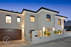 22A Livingstone Street Beaconsfield WA 6162 With views across the rooftops of Fremantle to the Indian Ocean and Garden Island, this near new two storey family home has been designed for entertaining and family fun just minutes from the vibrant heart of South Fremantle. Well appointed and immaculately presented on an elevated easy care block, this home represents sophisticated yet laid back family living with a casual indoor, outdoor lifestyle in mind. Accessed via a quiet rear lane way this private and secure home with double car garage and plenty of storage is set over two levels. The first floor is open and light offering an open plan kitchen, living and dining with a spectacular view across the Indian Ocean and Garden Island. With Rose Gum timber floors, high ceilings and plenty of natural light, it is about relaxed family living with the stunning Western Australian coastline as its natural back drop. A spacious modern kitchen with pale Caesar Stone bench tops, crisp white cabinetry and stainless steel Bosch appliances, enjoys a picturesque outlook opening onto a spacious private deck with valley and ocean views. The upper level floor plan also incorporates an equipped theatre room with dividing doors and tiered leather seating leading off the main living space, for fabulous movie nights or watching the footy finals! A spectacular master suite with the same knockout views is the ultimate parents' retreat with its adjoining tiled terrace and ultra modern ensuite, with double vanity set into stone bench tops and an expansive double shower. The lower level floor plan incorporates a study and three generously sized bedrooms, all with built-in robes, and a contemporary second bathroom with Caesar Stone bench tops, a bath with spa jets and floor to ceiling neutral tiling. A large under stair built in storage area is the perfect place to keep your favourite wine and books. Designed for entertaining, the alfresco living area is perfect for family gatherings, with its undercover outdoor kitchen, barbecue area and wood fired pizza oven. An L shaped, heated pool with water feature, swim and spa jets, tucked behind glass fencing, makes it an easy space to welcome family and friends in an informal outdoor setting. Sitting just moments from the centre of South Fremantle's bustling cafe strip, a short walk to Beaconsfield Primary and within easy reach of parks, beaches and transport, this near new, impeccably presented, low maintenance home offers up ideal family living in a quiet and secure setting. 4 BED, PLUS STUDY, 2.5 BATHS 2 CAR