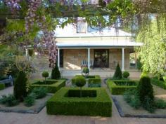 Wentworth Falls NSW, 2782 This elegant country home is beautifully sited on over 1640sqms in the heart of the village side of Wentworth Falls featuring Golf Course vistas on two sides. An outstanding, thoughtfully detailed, beautifully presented sandstone colonial style home, with four good size bedrooms, three bathrooms, a formal sitting room, separate dining, plus informal living and a simply gorgeous eat-in gourmet kitchen with oodles of space. Features include the high 9' ceilings, hydronic central heating, ducting for vacuum system and the very special tranquil north facing parterre garden. These mature designed grounds come with a fountain, wisteria draped pergola, camellia hedges and exotic cold climate plantings. PLUS, a double garage, laundry, and the rear garden has a good size studio, workshop, walled vegetable garden and very smart chicken pavilion!