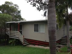 22 Ashton Street Macleay Island Qld 4184 Situated in a quiet Street this lovely home is kept private from the road with established large shrubs at the front of the property. It is fully fenced with 6 ft fences at the back of the lovely yard that has beautiful massive palms among the gardens. Enjoy summer with your fenced swimming pool and barbecue on the huge decks on the side and back of the home. Downstairs is perfect if you wish to work from home, with an office set up in one of the rooms and another room free as a 3rd bedroom. The two bedrooms upstairs have fans and wall heaters as well as built in wardrobes. The home has raked high ceilings for an extra feeling of space. There is a bathtub and separate toilet, and the kitchen is modern and spacious. There is air conditioning in the main living area which has screen doors out on to the deck. There is also a double carport and garden sheds. A lovely home, close to the jetty and shops. The vendor would love to rent back the home after sale, so you have a built in tenant if you want one.