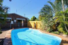 43 Gahans Rd Kalkie QLD 4670. Brick home, 3 bedrooms, extra large lounge, large open plan kitchen/
air-cond dining which opens onto the pool area, big shed, large
undercover entertaining area plus more all this for a mere $310,000
unbelievable. All three bedrooms will easily fit queen size beds, are all built in and have fans. The main has a semi ensuite. The
good sized kitchen is open plan to the air conditioned dining area.
This opens to the pool area and also to the large fenced front yard,
perfect for the children to play. An extra large lounge area with
floor to ceiling windows allows the natural light through and has more
than enough room for the largest of lounge suites Now the big
shed has room for 3 vehicles, is powered and has an air-conditioned
office/4th bedroom under the same roof. This area opens out to the
entertaining area. Entertain the largest of gatherings in the
undercover paved entertaining area, with built-in bbq, large back yard
and the in-ground saltwater pool. One can also make this a double gate
side access if required. This property is fully fenced is
situated in a quiet area and close to schools, transport, shopping
centres, restaurants, hospitals, CBD, and only a 15 minute drive to
sandy beaches it's all here at a price you can afford At a Glance: Land Size: 812m2 Bedrooms: 3, ceiling fans, built-ins Lounge: Large open plan, fan, floor to ceiling windows Bathrooms: 1 Toilets: 1 Water: Town Water Car accommodation: 3, Double Roller Door Garage/Shed Air Conditioning: Dining/Kitchen area Outside: Entertaining: Large Back covered patio, built-in bbq Inground Salt Water Pool Front fenced yard, lots of room for the children to play Good sized back yard also. Access: Double gate side access can be done if required Agent: Julie Lyons Phone: 0408 795 767