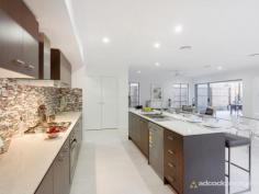 46 Dell Rd St Lucia QLD 4067 A truly superlative locale that is quiet and leafy, yet is within 200m
of the University of Queensland, brings a central advantage to this
newly completed contemporary residence. Built over two meticulously
finished levels, the well designed home incorporates open plan living,
alfresco spaces and a relaxed liveability that is well suited to a low
maintenance lifestyle.
Indoors and out, neutral finishes bring timeless appeal, while quality
fittings and fixtures, including Caesarstone bench tops and timber
veneer cabinetry all contribute to the polished, sophisticated feel.
Additionally, a judicious use of both translucent glass and high-set
windows ensures maximum light and natural airflow throughout the home,
without compromising privacy.
Surrounded by space for living and dining, the streamlined kitchen makes
a strong style statement in the main living area, with rich mocha
tones, stainless steel appliances, plentiful cabinetry and a walk-in
pantry. Stacking doors allows for easy integration with the outdoor
living room, while the adjacent media zone brings a separate space for
more sedentary pursuits.
Upstairs, four large bedrooms all have integrated wardrobes, with the
main suite making use of a walk-in wardrobe and a spacious ensuite
complete with dual, above-counter basins and a separate toilet. There is
a secondary living space on this upper level - ideal for children or as
a casual lounge, while a powder room, study, air-conditioning and dual
car garage completes the detailed offering. Outside, the easy-care yard
brings a secluded space to relax, with tidy gardens, a patch of green
lawn and a timber sundeck for lazing about.