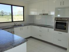.Yengarie, Qld 4650.Built by 2014 Master Builders Award Winner Dirran Knight (Knight
Constructions Qld) – winner of the 2014 Burnett Wide Bay "Rising Star
Award”, this lovely and new four bedroom home is waiting for its new
owners.
Positioned towards the rear of a three acre fenced allotment which
comes complete with a three bay shed and a lovely rural outlook, it
won’t be waiting long!
Just completed this four bedroom home is located approximately ten minutes from the CBD.
The main bedroom features an ensuite with dual shower and walk-in
robe while the additional three bedrooms all have built-in robes.
Quality fixtures and fitting and floor coverings have been installed
throughout. The kitchen, dining and lounge area is open plan in design
and large modern tiles feature throughout the main traffic areas.
The custom built kitchen which overlooks the rear deck boasts plenty
of bench space, dishwasher and a generous pantry. The rear hardwood
deck/entertainment area is fully lined, has lights and a ceiling fan and
is positioned to catch the afternoon breezes. The outlook across the
neighbours dam is lovely to look at while entertaining family and
friends.
There is underground power to the house and a large 10.6m x 7.5m shed
takes care of vehicle accommodation and workshop requirements.
“Brand new and waiting for you.”