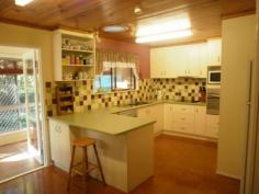 22A Cawdor Road Highfields Qld 4352 Older styled home set among established gardens on a large level private block. A classic Highfields location. 4 bedroom, 2 bathrooms, plus 2nd toilet in the shed. Large family/ dinning room, air conditioned and wood heater. Kitchen meals, cork floors, electric appliances, walk in pantry. Front veranda and dining area. Sun room and entry porch at the rear. Separate garage with shower and toilet, built in office and workshop area. Open fenced yard plus fenced rear yard for the dogs. Established garden that includes; fruit trees, veggie patch, large shade house, garden shed, chicken run and 5000gal tank plumbed to the house.