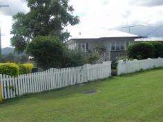 82 Atthow St Kilcoy QLD 4515 This beautiful 3 bedroom weatherboard home is situated in one of Kilcoys
best positions. Close to the Golf course and hospital and perched up
high enough to take in the glorious mountain views and catch the cooling
afternoon breezes.
The home itself has a wonderful warm feel about it and has been
lovingly and thoughtfully renovated to recreate the cosy feel of
yesteryear. The kitchen is a chefs delight with plenty of bench space,
and a gas cook top. The adjoining dining room is airy and spacious and
opens onto the deck which is perfect for entertaining. A private roomy
lounge and two good sized bedrooms (both with built ins) and bathroom
complete the upstairs. The upper level of the home features gleaming
polished timber floors. Down stairs is the third bedroom with ensuite (
perfect for the teenager or elderly parents), laundry and room for
entertaining and car accommodation.
The home sits on a 993 sq mtr corner block is partially fenced and has low maintenance gardens.