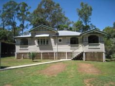 Blackbutt QLD 4306 This Queenslander has original features, and was fully renovated in 2010. It has 3 bedrooms( 2 with built-ins) set on 1128m2 town block with all amenities and close to the school.The original features include high VJ timber ceilings, polished flooring with a wood heater, VJ walls throughout, with decorative timber features and stained glass french doors leading to an expansive verandah.The lounge & dining room both open out onto the verandah & into the family/sleepout room. A lock up garage , for a single car is at the front of the property. The laundry has a 2nd toilet & vanity , with a small veranda with french doors to the master bedroom .It is currently rente on a month to month basis.