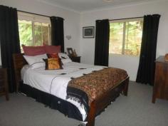 Murwillumbah, NSW, 2484 Room to move on this 1 1/4 acre rural living block with town water at Dallis Park backing onto farmland with lots of privacy. A stylish & elegant family home of 4 bedrooms, 3 bathrooms, large open plan living opens out to the verandah taking in the fabulous rural views. A great potential to configure the downstairs living area to a granny flat for the extended family or guests and meandering pathways flow through the beautiful rainforest gardens.