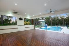 9 Warrandyte Court Camp Mountain QLD 4520 Position is a key feature that differentiates this property from others in the Samford district and indeed acreage properties in Brisbane generally. Only 7 mins to Ferny Grove train station means transit to the city centre and events is easy and quick. Driving time is only 30 minutes to the city. Uniquely situated at the base of Camp Mountain, bordering the D'Aguilar National Park, with nature trails right at your doorstep, lies this hidden gem on 3.75 acres. Privacy is paramount and the new owners will enjoy a chilled and relaxed lifestyle with the assets that abound. A recent extension by Garth Chapman Queenslanders has created a large 6.8 x 6.5m outdoor pavilion. Such a beautiful space, it has everything you need for entertaining in style built in seating, BBQ with stone bench tops, storage areas and tv points, ready for your widescreen TV. Take 2 steps down from the pavilion and you are in your massive, granite paved sparkling pool area with semi frameless glass fencing, hot water outdoor shower, beautiful water feature and a pump room that is impressive in itself, allowing convenient storage for chemicals, pool toys etc. This will be a place you will be very proud to entertain from. Adjacent to the pavilion area is the kitchen has had a recent update whilst retaining its farmhouse kitchen styling, with stone bench tops, step in pantry and quality 900mm Smeg freestanding oven and gas cooktop. Large windows open out to a servery, and are conveniently positioned to make entertaining a pleasure. This majestic north facing Queenslander has 15 foot vented timber ceilings and careful window and silky oak French doors to the wide verandahs. This home is very cool during the summer months and with the use of the ceiling fans has no need of air conditioning. The family room features a brick open fireplace, ensuring many winter months enjoyed by the warmth of the fireside. The bedroom wing has of 4 bedrooms, 3 of which have new built in wardrobes with custom shelving. These all open out to a rumpus area with floor to ceiling sliding doors which open up to allow further breezes to flow through. The master bedroom is spacious and features a large walk in robe and ensuite with sunken spa bath and sash windows that can be opened up to enjoy the views while soaking the day away. Downstairs, a recently built 6m x 6m office is perfect for those who work from home with its separate entrance, but could be used as a teenage retreat or media room perhaps? The owner has taken advantage of the lands natural drainage, which allows water to flow to the dam with pumps for irrigation to the gardens and a total of 80,000 litres of water storage ensures you should never run dry.