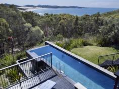 35-37 One Mile Close Boat Harbour NSW 2316
Set on two separate blocks just two hours from Sydney, this exclusive
Boat Harbour hideaway is flanked by National Park. Conceived as a pair
of interconnecting, Eco sensitive pavilions, the house has an elegant
design and exquisite indoor and outdoor living areas, all with a
breathtaking northerly outlook across bush, beach and bay.
Three gorgeous bedrooms, the luxurious master set in its own
pavilion, open plan living and dining with fireplace, family or billiard
room, stunning kitchen with Caesar Stone bench tops and European
appliances, divine bathrooms, "infinite edge" lap pool and cascade,
extensive native gardens, polished timber floors, abundant light and
triple garaging.