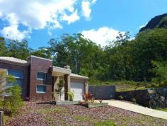 99 Springburn Dr Glass House Mountains QLD 4518 Your very own natural bushland setting, positioned on a huge 2872m2 block at the foothills of Mt Ngungun. This is the perfect spot to come home to after a busy day or raise the children in this peaceful safe environment. Upon inspection you will appreciate the upmarket quality and design features built into this beautiful family home. Presenting as new and offering 4 double bedrooms, ensuite , stunning caesor stone kitchen with gas cooktop, canopy rangehood, 900mm oven, glass splashback and a huge breakfast bench, large open plan living/dining areas and an oversized entertaining area with decking, fans and up close views of Mt Ngungun.