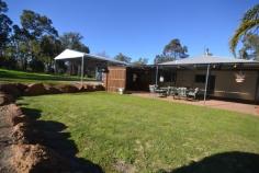 BRING THE HORSE AND THE KIDS
This large hardy plank and iron
homestead is the ideal family home, it has 4 bedrooms plus a study, two
modern Bathrooms, enormous open plan living area and more.
Outside is a large patio with bar and a landscaped pool area . If you
need sheds there are plenty, 4 garages plus workshop, carports and a
studio. All situated on 5 pasture acres just a short drive from Chidlow.
> Lovely 4/5 Bed H/P/I Home
> 4x Garage + Workshop
> 2 Modern Bath, Huge Laundry
> Enormous Open Living
> 5 Pasture Acres, 3 Carports
> Bore, Tanks, Landscaped Pool
