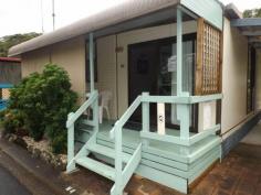 N4 White Albatross Nambucca Heads NSW 2448 Entry to this home is via a glass sliding door from a private front verandah, located in the White Albatross Over 50's Park at the entrance of the beautiful Nambucca River. A fresh feel to the lounge room on entry has glass mirrored tiles giving length to the room. The lounge and dining with new carpet underfoot flows through to the kitchen, with the added comfort of air conditioning. The kitchen with new timber look a like vinyl flooring, comprises of electric upright cooker and range hood. Adjacent to the lounge is the 2nd bedroom with glass sliding doors to a back verandah. This room also has direct access to the bathroom as does the main bedroom. Leading from the dining room, with new carpet and mirrored built in robes is the main bedroom. The bathroom come laundry, has a toilet, vanity, shower and linen cupboard. There is convenient room for a washing machine within this area. Externally the property has a single carport, with paving to the rear. A covered back verandah has shade cloth blinds and a great area to hang washing on a rainy day. Step down to a delightfully maintained lawn area with bush further a field, this outlook is definitely a feature of the property.