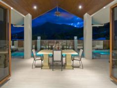 1 Wirrega Close Caravonica QLD 4878 The Judges Choice for 2010 Master Builders Association Awards 2010 Best Bathroom Best Design For The Climate Housing Industry Association Awards 2010 House Of The Year Best Custom Build Home Of The Year Located in Cairns most prestigious estate, only a 10 minute drive from the international airport and 15 minutes from Cairns City Centre, this 5 star resort style home is designed for the tropics with cross flow ventilation and air conditioned throughout. The huge designer kitchen has top quality appliances and stone bench tops, with self closing drawers, overlooking the sunken leather lounge and wet bar. The fabulous pool and spa is complimented by a fully tiled alfresco dining and tropical garden area, surrounded by magical mountain views. The master bedroom with spa access, views and enormous ensuite, a formal dining room, powder room and office with separate entrance for the professional complete this pavilion. Three generous bedrooms with built-in robes, unique bathroom, fully equipped laundry and walk-in linen storage area finish the second pavilion. The third pavilion consists of a four car garage, with 3.5 metre access for all the boys toys. The gatehouse entry continues into the fully covered timber breezeways connect the pavilions which are complimented with tropical plants and automated lighting.