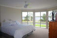 23 River Road East Harwood NSW 2465 Property Description Harwood Haven We all know when looking for a property to call your own you should look for presentation, position and price. From the moment you arrive to inspect this impressive riverfront family home you know you’ve got all this and so much more. This home is a true delight with outstanding presentation inside and out and taking in the amazing Clarence river views. Boasting a family friendly design you can’t help but be impressed by the separate formal living and dining areas as well as the open plan tiled meals and family rooms, all of which are light and spacious. The modern kitchen is fully equipped with loads of cupboard and bench space and even includes a dishwasher. All four bedrooms are generous in size and the master bedroom comes with its own walk in robe and ensuite. A handy 5th room come home office/craft area is also on offer. Fitted out with ample cupboard space for storage and a generous area for the family computer and desk or your latest challenge to be worked on this versatile room makes family living that much easier. If you love entertaining family and friends in style then you will be delighted with the waterfront under roof patio area that opens up from the family room. You’ll have no worries about where to store the family tinny or trailer as in addition to the extra-large remote double garage there is generous side access onto the large concrete pad. Property Features Land Area 1,016.0 sqm