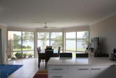 23 River Road East Harwood NSW 2465 Property Description Harwood Haven We all know when looking for a property to call your own you should look for presentation, position and price. From the moment you arrive to inspect this impressive riverfront family home you know you’ve got all this and so much more. This home is a true delight with outstanding presentation inside and out and taking in the amazing Clarence river views. Boasting a family friendly design you can’t help but be impressed by the separate formal living and dining areas as well as the open plan tiled meals and family rooms, all of which are light and spacious. The modern kitchen is fully equipped with loads of cupboard and bench space and even includes a dishwasher. All four bedrooms are generous in size and the master bedroom comes with its own walk in robe and ensuite. A handy 5th room come home office/craft area is also on offer. Fitted out with ample cupboard space for storage and a generous area for the family computer and desk or your latest challenge to be worked on this versatile room makes family living that much easier. If you love entertaining family and friends in style then you will be delighted with the waterfront under roof patio area that opens up from the family room. You’ll have no worries about where to store the family tinny or trailer as in addition to the extra-large remote double garage there is generous side access onto the large concrete pad. Property Features Land Area 1,016.0 sqm