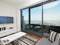 6003/7 Riverside Quay Southbank VIC 3006 Maximising wraparound Albert Park, MCG, Botanical Garden views to bay view, this resort style skyhome reveals a scenic retreat graced with a cleverly integrated in/outdoor design to bask in the vibrancy of Melbourne from each and every window. The defined living and dining areas capture picture views and soak up an abundance of natural light. An open granite kitchen is equipped with Miele appliances and seamless cabinetry. Residents enjoy access to a premier selection of facilities including a gymnasium, pool, sauna, private cinema, 24 hour concierge and video intercom and lift access. The double-sized bedroom includes wide built-in wardrobes and direct access to a stylish ensuite. Additional features include a separated laundry, guest powder room, ducted air conditioning, chic downlights and single carport. It represents a remarkable investment opportunity for those seeking an unparalleled lifestyle location with popular demand and a high rental yield. It is proudly set on the 60th floor and enviably located within easy walking distance to sports venues, Crown Casino, Arts precinct, Southbank shops, cafs, restaurants and transport options.