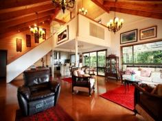 4 Maple Court Beechmont Qld 4211 YOU WILL LOVE THIS MOUNTAIN-TOP PENTHOUSE. Few homes on the mountain match this superb property for it's 'chalet style' so often sought by discerning buyers. There is a wow factor from the moment you step into the huge entrance vestibule. Immediately visible are the soaring timber lined cathederal ceilings that vault the large open plan living area.This light and bright space is at once both tranquil and inspiring,the warmth of the timber echoed by cork flooring. In 2010 this house was completely refurbished including installation of new 'miele' equipped kitchen. Unobtrusively tucked amongst lush mountain greenery on the rigetop overlooking the stunning Numinbah Valley a private rear deck offers mesmerising views from the Gold Coast skyline to the towering cidatel of Springbrook Mountain across the valley. This is a masterbuilt home that will enchant the buyer seeking a special property in a quiet and very beautiful part of the Hinterland--yet less that 30 minutes to the coast.