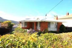 16 Barnett Ave New Norfolk TAS 7140 Walk To Township Low maintenance two storey brick home set on an elevated 806m2 lot with pleasant rural and township views. Featuring 3 bedrooms, good sized kitchen/dining and a separate loungeroom. Separate studio and rumpus under with toilet, shower and vanity. Rumpus could be used as the 4th bedroom if needed. Outdoor patio BBQ area ideal for entertaining and taking in the views. Only a short walk to the town centre where all conveniences are available. Classic example of late 1960’s architecture. Double garage, tool shed, room for a veggie garden and children to play. Modern 250 litre energy saving evaporative tube hot water unit on roof. Also efficient gas heater in lounge along with a choice of new R/C Heat Pump. Call for an inspection today!