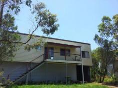 55 Wirralee St Macleay Island QLD 4184 This tidy two bedroom home also has a workable study which could always be used as a third bedroom. The house will surprise and delight you when you walk in the door. A highset home with a bushland view near the water in a quiet no through road. Underneath the property is build to legal height so it would be possible to extend downstairs at a later date.
