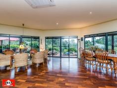 23 Walden Close Gidgegannup WA 6083 Inspections Inspections by appointment only. This rural and much sought after village on the edge of metropolitan Perth, has many superb life styles to offer. This 6.2 acre property would have to be classified as your own piece of paradise, secluded and far away from the maddening crowd with the hustle bustle of the city. It borders other large properties with one great neighbour, Please allow me to give you a little tour, starting with pines and an electric gate/intercom, a welcoming feature on wet and windy days. The 150 metre trees and shrubs lined driveway brings you to a large parking area, a double car port and double shaded parking. A lovely elevated home, flanked by bush further compliments this great setting. The pond, the sound of 3 waterfalls, lush green rockery and a backdrop of unique and unusual panels, gives the outdoor entertaining area a special feel. Open living with 180 degrees views over a native garden, bushes and trees that seem to ramble on into the distance over this gently sloping property. The split kitchen is a cook’s dream where dirty dishes and evidence of a great meal are hidden from view by a low curved feature wall. It also features a new gas cook top, electric oven. The property boasts a large master bedroom with private ensuite and walk-in-robe as well as a large double guest bedroom and a smaller double bedroom both with built-in-robes. There is also a office/single bedroom overlooking this amazing property. The main bathroom is large and is beautifully presented with a spa/shower and toilet. The pristine jarrah flooring flows through the home and along an extra wide passage way with bookcase. The high ceilings, tinted windows throughout and the cosy wood fire resonate the perfect setting to unwind and enjoy the stunning views from this beautiful property whilst reading, relaxing with family or entertaining. A solar hot water system with gas booster and a solar tracker run endless hot water to the property using the sun hitting the large roof span to reduce your electricity costs. Outside the property features a wrap-around verandah for relaxing and taking in the breathtaking sunsets. The property is also fire ready with permanent gutter guard, 24m span large sprinklers, extra-large electric cable, firefighting pump and hose and 12000L and 150000L water tanks. Hundreds of graceful grass trees (black boys) some ancient surround the home, together with the many shrubs and trees that make this property lush and green all year round. A small path meanders through the bush to a netted vegetable garden, 2 open patches and a 6m x 3m potting shed with electricity. Next to this is a 12000L water tank fed by a 600 gallon an hour bore for watering with a new pump. Currently three quarters of the property is reticulated with automated sprinklers and a float switch regulates the water level. There is another 6m x 3m workshop also with electricity, a work bench and shelving on both sides for storage. Then there is a 6m x 3m ventilated storage shed. Just down a slope your eye will catch citrus and exotic fruit trees as well as 2 almonds, and a pecan tree, all artistically netted and weed protected by a weed matt and top dressed with very fine gravel. Further down a chicken coop, enclosed to make it fox proof and house on stilts, with easy access to eggs. This is part of a larger open enclosure, ideal for geese, ducks, goats etc. A circular driveway leads to steps and a 150.000 Lt. rain-water tank that sits on the other side of the house together with more netted exotic fruit like, Jube-Jube , Persimmon, Pawpaw, Pomegranate and another Shartoot all hidden from view. Jezzabelle the pet kangaroo was brought up in the house and considers this her home. She will delight you when she comes to feed with her current joey. Wild ones will come down in the hot summer to feed at the kangaroo patch just below the house which is kept green with two large sprinklers. There are several great secluded spots to sit with a book overlooking a dam across the bridle path or you might
enjoy the green rolling pastures across the fire break. Close to the house is a great spot for a fixture or an umbrella and some chairs, marvelling at the lovely view, bush orchids and wild flowers. This area is ideal for entertaining with friends or family. There is ample room for a pool or to keep animals. The local schools at Mt Helena are only a few kilometres away and there is a bus stop 100 metres from the front gate of the property. • If you are ready to make the tree change and looking for seclusion and nature at its best, waking up to the sound of kookaburra’s. • If you marvel at the sight of an eagle soaring high in a clear blue sky or watch a flock of red tailed cockatoo’s resting in their favourite tree. • If you like to be surprised by a bobtail wondering past or like to surprise a sleeping sun drenched goanna on the driveway. • If you like to spot an unsuspecting bandicoot or get excited by a heron, gingerly negotiating rocks to snatch a fish from the pond. • If you enjoy watching galas, twenty eights and magpies or beautiful bright blue wrens all vying for position at the feeder just outside the window. THEN THIS CAN ALL BE YOUR INSTANT PRIDE AND JOY. The owners have lovingly spent many years of dedication to this once virgin piece of land which has so much to offer that no photo or description would do justice to the magic that surrounds you here.