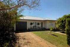 3 Norah St Centenary Heights QLD 4350 This beautiful chamfer home sits on a roomy 647m2 in the highly sought after pocket of Centenary Heights. Set in a quiet cul-de-sac, it is perfectly located close to popular schools, Southtown shopping precinct with its busy cafe's and eateries and is surrounded by nearby parks and playing fields. You will fall in love with the warm polished timber floors, 9ft ceilings and large classic timber doors and windows. Immaculately presented, the home boasts fresh paint and new, quality carpets throughout. An open-plan lounge room with charming French timber doors opens onto a small front deck. This living area flows seamlessly into the large dining area and both these rooms receive the comfort of newly installed reverse cycle air conditioning. The huge kitchen offers plenty of cupboard and bench space for those who love to cook. From here, you can overlook the fully fenced backyard with flowering gardens, shady trees and plenty of space for your pets and children to play. There is also a wonderfully positioned north facing outdoor covered entertaining area which easily fits a BBQ and large dining table. The three bedrooms are all well-sized, two having built-ins and the third opening onto a sweet, sundrenched sitting area perfect for a cuppa and a good book. The romantic king-sized master suite enjoys warmth and natural light from large, elegant windows. The single lock-up garage with internal access also boasts storage space and is cleverly positioned to the west of the home. The home has direct access to the playing fields of St Thomas More's Catholic Primary School, is walking distance to Centenary Heights State High School and falls within the Rangeville Primary School catchment. This charming home represents freshness and elegant simplicity and discerning buyers will recognise the excellent value of this property.