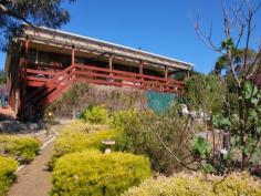 54 Signal Hill Road, Dodges Ferry, Tas 7173 Beautiful Home - Beautiful Price Everywhere you look and everywhere you walk there is something to catch your eye, something to capture your imagination and somewhere to sit and ponder or meditate. The superb landscaped grounds are inviting, the spectacular views are just breathtaking and the man of the house has a choice of sheds to potter in. A large circular driveway, a massive triple bay garage and a driveway to the bottom of the yard where there are more sheds. A magnificent approx. 12 metre long entertainers deck with bistro blinds for year round use... and this all before you get into the house. Park in the carport and gain access to the home through the front entry. Welcome to a warm and inviting split level home, with the living areas all on the bottom level making full use of the spectacular views and the bedrooms all on the upper level and looking out onto landscaped front gardens. A modern solid wood kitchen, lovely dining area with sliding doors to the deck and a cosy lounge room kept warm by wood heater, all enjoy views from Seven Mile Beach, to Lewisham and Mt Wellington. The three bedrooms are a nice size, two with built-in robes and all finished off with quality blinds and drapes. This is the complete package and brilliantly priced.