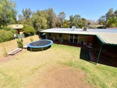 4 Beefwood Court Sadadeen NT 0870 Family Home and Studio Nestled on a 1020 sqm2 allotment in a peaceful cul de sac in a family friendly neighbourhood with a lovely park nearby. This lovely home offers multiple living spaces and modern living for the family with a park is nearby for your enjoyment. As you enter the home you will be impressed with open plan central living area which feature French doors that lead out to the fabulous outdoor undercover entertaining area. The contemporary gas kitchen is adjacent to this room and is ideal for the keen chef, with plenty of bench and cupboard space. There is a cosy second living area off the kitchen as well as a bedroom and the main bathroom. The other three bedrooms feature built in robes and the main bedroom features a bay window a lovely ensuite with spa bath, separate shower. A combined self-contained studio /workshop is located in the back yard and features a guest bedroom, small kitchenette and bathroom. There is scope to develop this further with rental possibilities. Additional features comprise of undercover parking, solar hot water, a combination of ducted evaporative air-conditioning and reverse cycle air cooling and under cover car parking for three cars.