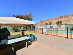 4/16 Bradshaw Drive Gillen NT 0870 With prime elevated views of Heavitree Gap as well as panoramic East and West MacDonnell Range views it will be hard to stop looking. This two bedroom first floor unit has all the trappings of the ground floor units without a private yard. There is still plenty of common area to enjoy a social BBQ, swim in the pool or just read a book in the resort style garden setting. The entire unit has vinyl flooring and ducted evaporative air throughout. Open plan living is the theme in the lounge, dining and kitchen areas while the bathroom has a bath, shower and toilet. A real bonus with this unit is a 12m x 6m insulated shed that has had a lot of detail added to the inside. Divided into sections to accommodate a garage, a storage area and a games room/studio it is still diverse enough to cater to an individuals specific needs. The grounds are immaculate and recent kerbing, bitumen & line marking make private off street parking a breeze. Priced to sell to either the astute investor or happy home owner.