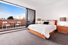 105/18 Bent Street Kensington VIC 3031 Luxury and Lifestyle with Spectacular City Views This stunning two bedroom apartment within “The Kensington” boutique complex, epitomises everything urban living represents, boasting an ideal city fringe location, generous open floor plan and contemporary, elegant design. Bathed in natural light, a central gourmet kitchen separates dining and lounge, spilling seamlessly onto a huge entertainer's balcony with spectacular, sweeping city views. Stone wrapped island/meals and bench tops, luxury stainless steel Smeg appliances, glass splashback, pull out pantry and soft close Hettich drawers feature in the crisp, white kitchen, whilst the lounge boasts a sleek, minimalist fireplace. Two large double bedrooms with generous built-in robes, deluxe master with spacious fully tiled ensuite including bath, and a large private balcony, also with city views, provide excellent accommodation. Safety and ambience have been incorporated with central video surveillance, intercom, secure building and underground carpark (with storage) entry and a landscaped, elevated garden in the enormous complex courtyard. Other impressive features include reserve cycle air conditioning, quality carpets, tiles and timber flooring. General Features Property Type: Apartment Bedrooms: 2 Bathrooms: 2 Outdoor Features Carport Spaces: 1