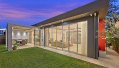 5 Goodwin Street Narrabeen Designed by highly celebrated Architect, Gartner Trovato, we take
pleasure in presenting a residence where no expense has been spared, a
creation that delivers a magnificent beach home that is simply
overflowing with modern design cues, easy functionality and a stream of
luxurious, hotel quality features and finishes.
Step through a grand entry to be immersed in a soothing palette of
cocooning colours, luxurious materials and natural flowing light which
showcase contemporary travertine flooring and sky high ceilings, fully
enhanced by floor to ceiling, energy efficient glass. With the entry
level focussing heavily on lifestyle and entertainment, the natural
indoor to outdoor flow is one of many factors that make this property
irresistible, with a mesmerising in-ground pool acting as a centrepiece
for all to admire and enjoy.
A sequence of entertaining zones embellish this residence, each more
beautiful than the last, with an arrangement of backdrops created to
capture ever single aspect of contemporary brilliance. Wide, open
planned design and clever integration of sleek, glass opening doors sees
these living and dining spaces integrate into one, collaborating the
indoors with the out, where one can enjoy a perfect Northern aspect
together with additional designer features which cleverly incorporate an
eco-fireplace, ducted zoned air conditioning plus multi-media smart
wiring capabilities.