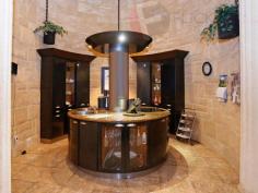 213 Tamarisk Drive Gabbadah WA 6041 EXEMPLARY RESIDENCE IN BEAUTIFUL GABBADAH. "DARING TO BE DIFFERENT" was the heading for this fabulous property when Homes & Living magazine did a story on it in their 2003 issue Design Trends. . Driving through the gated entrance to this fabulous property. with its mature trees and beautiful landscaped gardens , and stone water feature you know you have arrived. Sitting on generous 5 Acres of land this limestone home has it all , and more. The house was built by the owner a Master Stonemason with each stone hand cut, and by using a centuries-old keystone technique there are no lintels over any windows or door ways. A winding staircase leads to the Turret sitting room where you have beautiful views and another winding staircase to the Circular Cellar. The muli-level living area has seven meter timber lined high ceilings and also accommodates the circular kitchen by Alternative Kitchen Company with its rolled steel column and shimmering halogen overhead lights and Blanco & Delonghi appliances truly the focal point of this elaborate room. The master bedroom has a large walk in robe and a luxurious sunken spa bath to the En-suite perfect for relaxing after a hard day at the office. General Features Property Type: House Bedrooms: 3 Bathrooms: 3 Land Size: 2.02ha (5.00 acres) (approx) Indoor Features Ensuite: 1 Workshop Built-in Wardrobes Dishwasher Rumpus Room Open Fireplace Outdoor Features Remote Garage Garage Spaces: 2 Outdoor Entertaining Area Fully Fenced Outside Spa Swimming Pool - Inground Eco Friendly Features Water Tank Other Features RCDs, Deck, Terrace/paved, Courtyard, Indoor entertainment area, Outdoor entertainment area $990,000