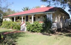 17 William St Millmerran QLD 4357 DETAILS $315,000 Residential Bedrooms: 4 Bathrooms: 2 Garage Spaces: 1 1st Time Opportunity—”The Post Office House” Available For Separate Sale – $315 000 Area: 1010 Square Metres – Renovated Queenslander with character and charm, 4 Bedroom timber home, all b/rs with ceiling fans & built-in storage, main b/r has ensuite & opens onto verandah, 2nd b/r has large w.i.r.. Large formal lounge room with fire place & ceiling fan, stylish main bathroom with shower over bath, toilet & vanity, wide hallway, wide polished original timber floorboards throughout, office, laundry with plenty of storage space, front verandah with northern aspect, single garage, under cover outdoor living area, cubby house, garden shed, established gardens, fenced yard. Only minutes to walk to the Main Street & all town amenities. Backyard access to Bowls Club