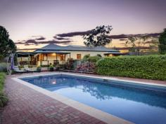 73 Phil Tunks Road, Dooralong The Epitome of Country Living
Gracefully poised on approximately 31 amazing undulating acres is
this stunning Dooralong Valley homestead. With a quintessential gated
tree-lined drive that is embraced by manicured mature gardens and a
generous outdoor decking from which to enjoy the stunning elevated rural
outlook; the country life does not get any better than this. Charming
warm interiors, French doors, stone kitchen and a dramatic sun-drenched
central living/dining space provide a versatile and functional floor
plan perfect for family living and entertaining. This incredible estate
also flaunts a full sized tennis court, sparkling 12 metre solar heated
in-ground pool, huge machinery shed plus stables and is all completely
fenced.